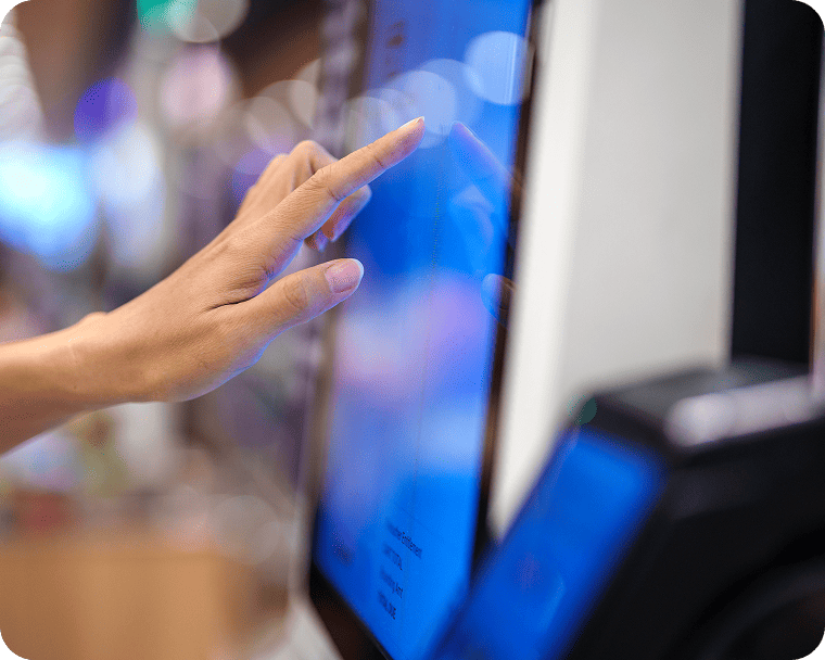 A customer places a food order from a quick service Genius Kiosk. 