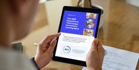 Person holding a tablet with a blue report page titled “The QSR Employee Experience That Keeps Customers Coming Back.”