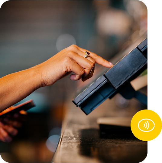 A person taps on a terminal screen with their finger.