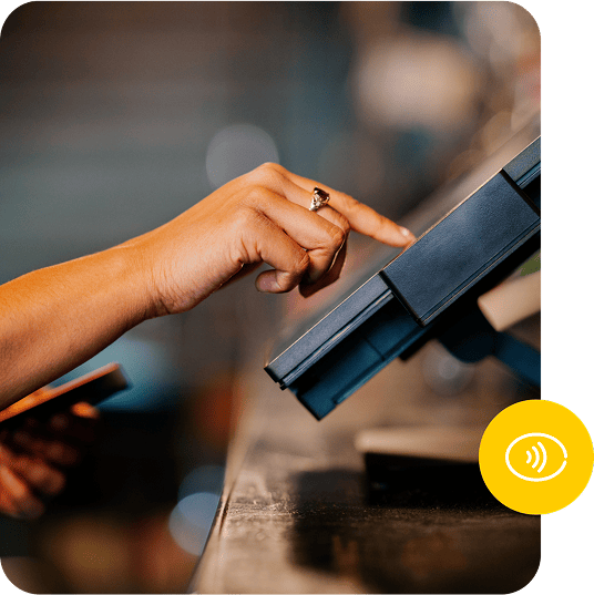 A person taps on a terminal screen with their finger.