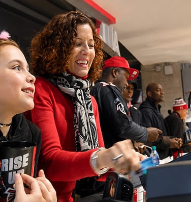 Woman paying with a credit card at a venue concession stand counter.