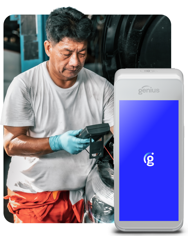 An auto repairman checks a car next to a Genius handheld payment device.