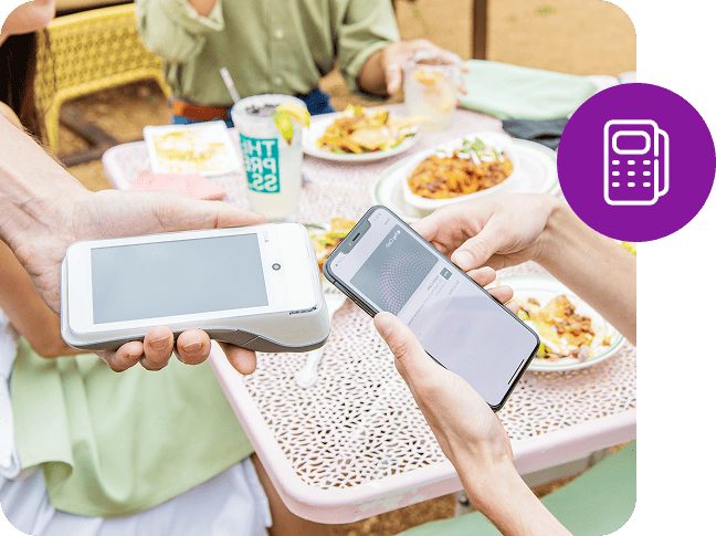 A mobile phone makes a tableside payment on a card reader.