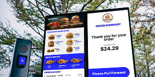 Photo of outdoor digital menu screen at fast food restaurant.