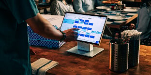 Man using central restaurant system for handling online ordering