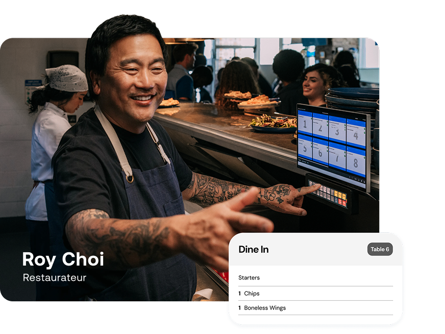 Man working in restaurant kitchen looking at digital order screen