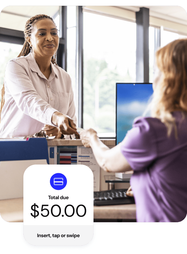 Customer handing a card at a reception desk with an overlay showing $50.00 total due.