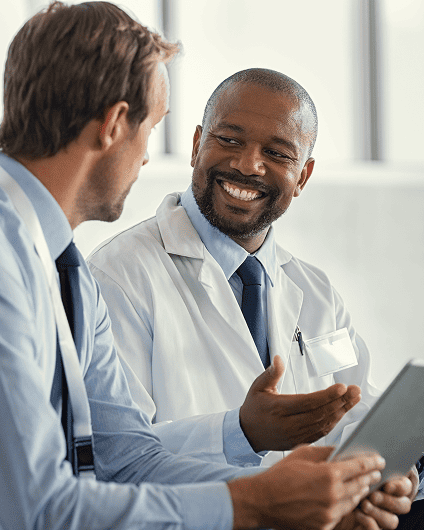 Two healthcare workers talking in an office environment
