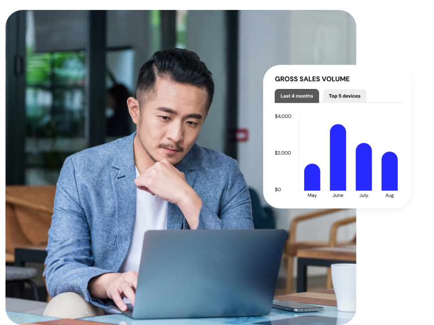 A business owner reviews payment reports on his laptop to gather data about his business’ performance.
