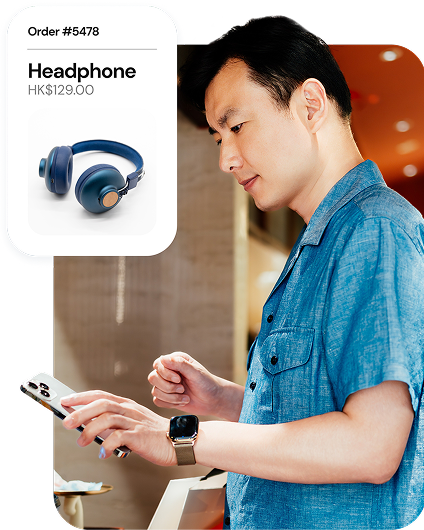 A customer buying headphones with his mobile device. 