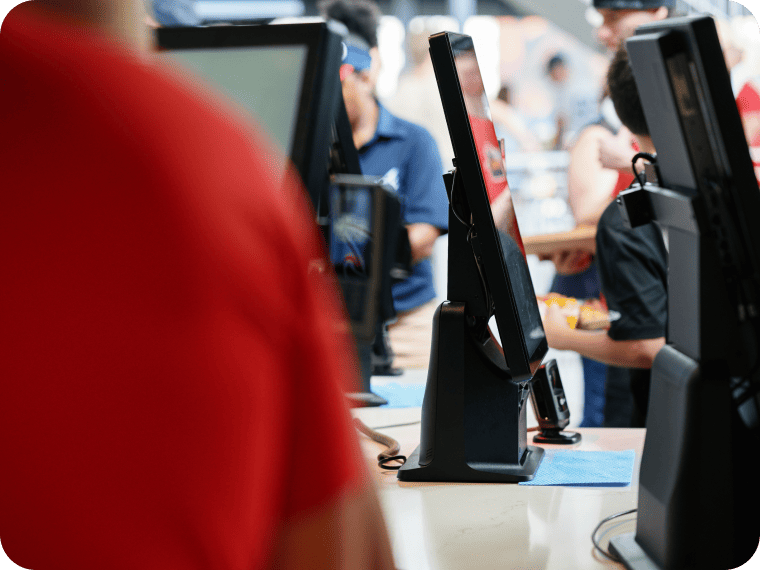 An image showing multiple self-serve kiosks inside a busy business.