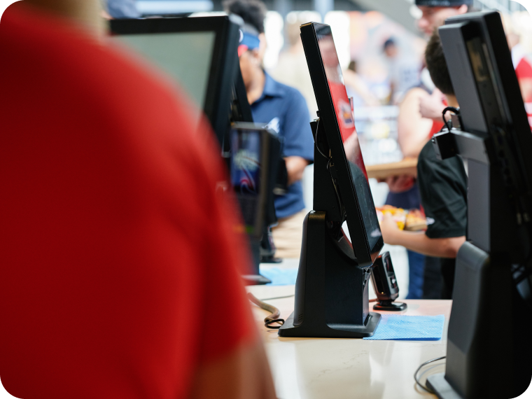 An image showing multiple self-serve kiosks inside a busy business.