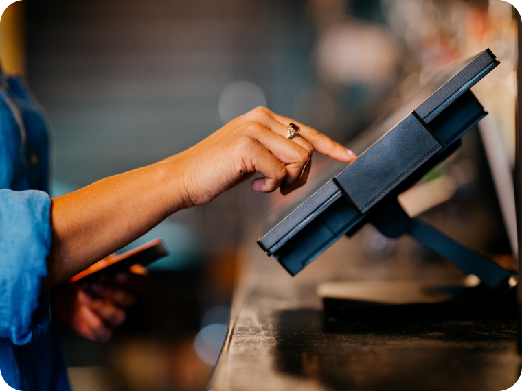 A close-up image of a person using a kiosk device.