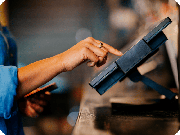 A close-up image of a person using a kiosk device.
