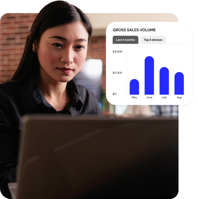 A woman sits at a laptop while a pop-out graphic shows she’s looking at a graph of sales metrics.
