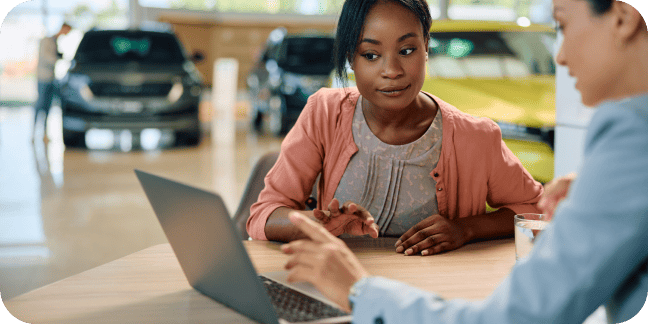 Salesperson showing a customer payment terms for a new car