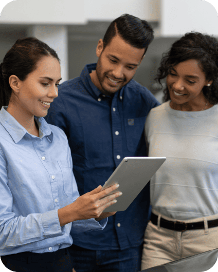 Car salesperson showing a couple their auto terms on a laptop at a dealership