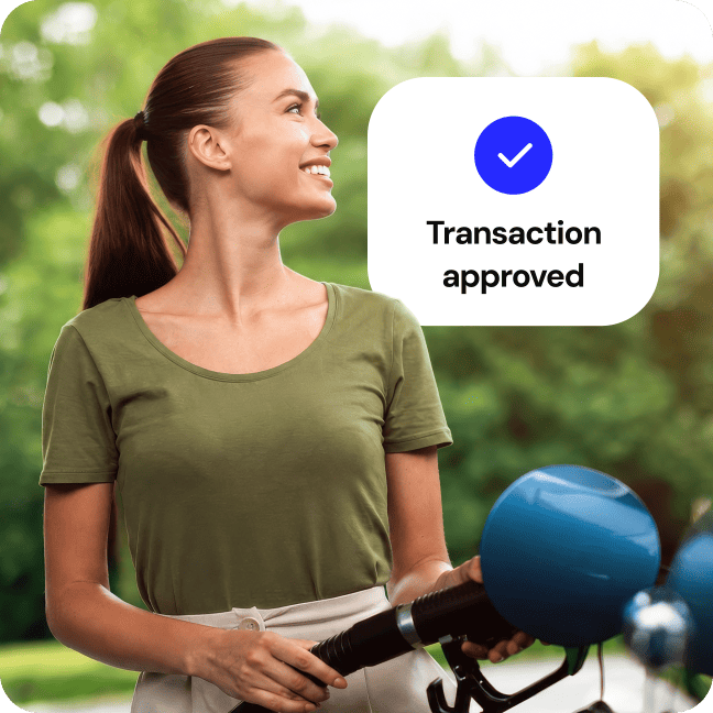 Smiling woman using a fuel pump with a "Transaction approved" graphic.