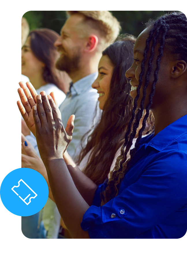 Smiling, diverse crowd clapping at an event with a ticket graphic.