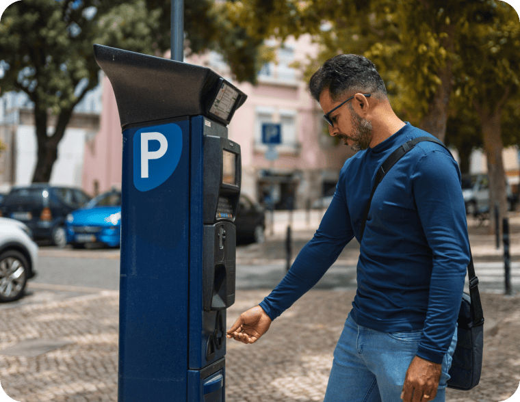 A parking customer gets a receipt for a payment from a parking kiosk on a downtown street.