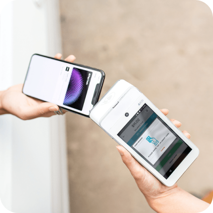 Two people use a smartphone and a payment terminal to complete a contactless payment.