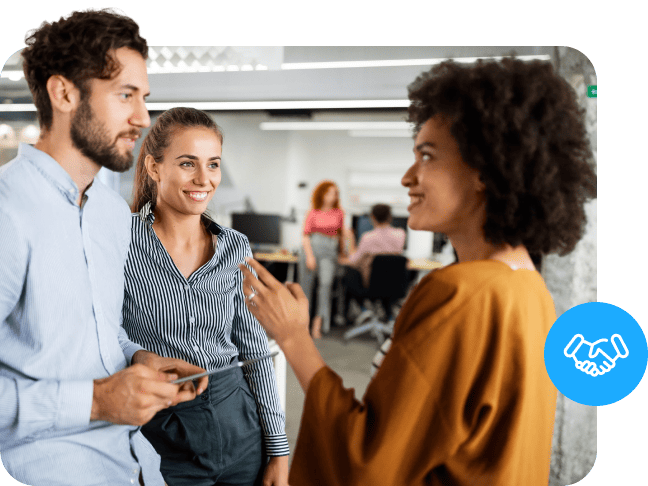 Three office colleagues discussing work with a blue handshake icon overlay.