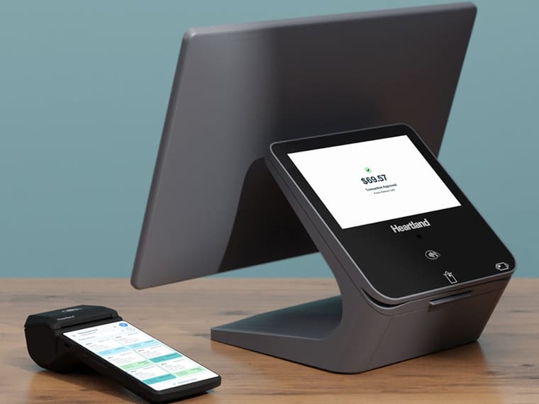 Heartland countertop point-of-sale system and mobile payment terminal on a desk