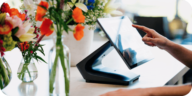 Worker uses countertop point of sale in retail shop.