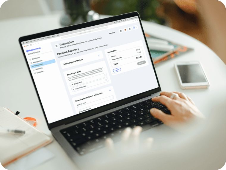 Laptop screen showing a payment processing terminal while a user types on the keyboard.