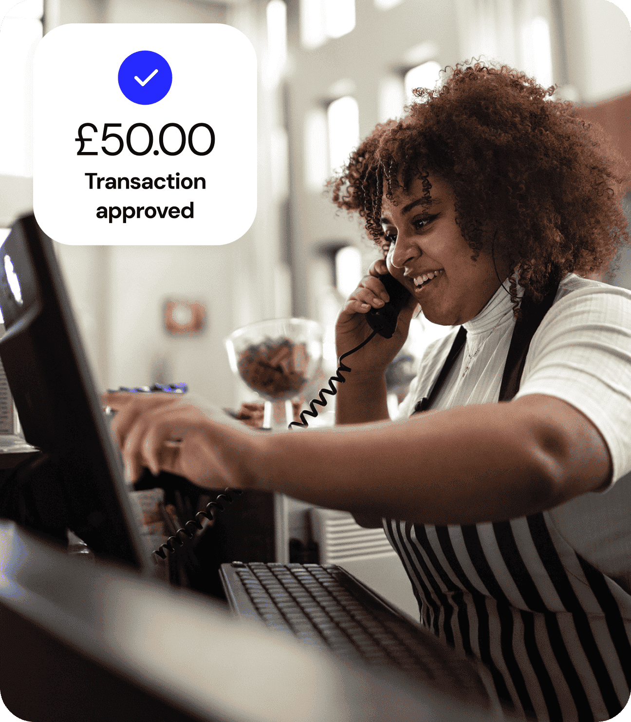 A barista takes a phone call while she’s making a coffee.