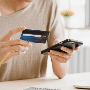 A customer makes a card payment on a mobile phone.