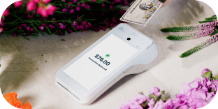 An image of a white handheld POS device displaying text that reads: “$76.00, transaction approved.”