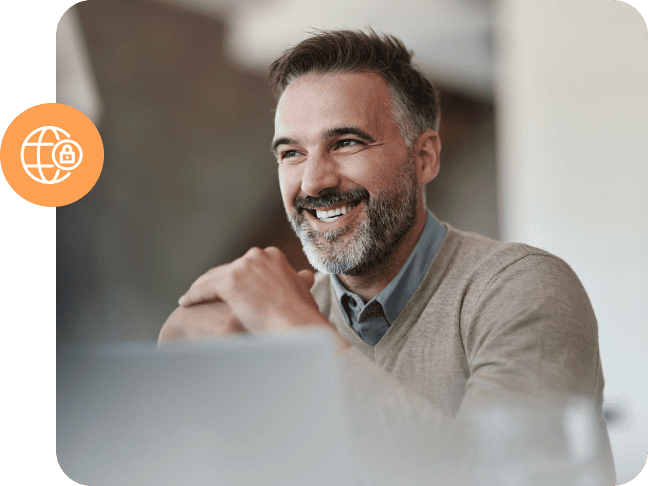A smiling man sitting at a desk with a secure web icon overlay.