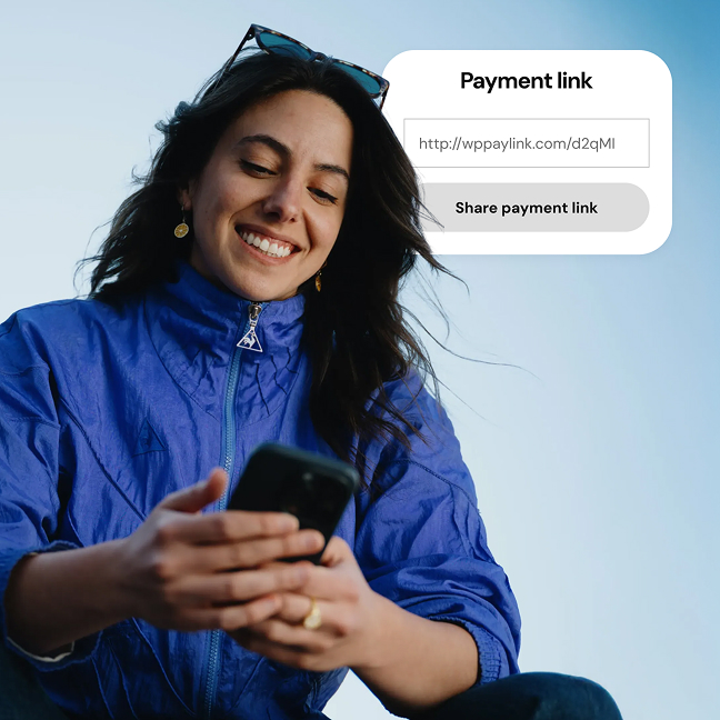 A person using a mobile phone with a payment link displayed.