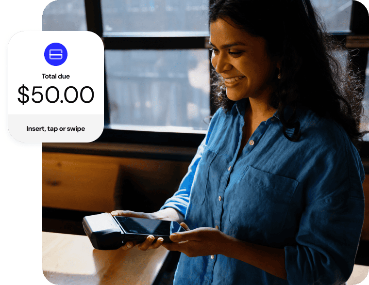 Woman smiling while holding out a mobile payment terminal. A screen shows “Total due $50” with the option to insert, tap or swipe