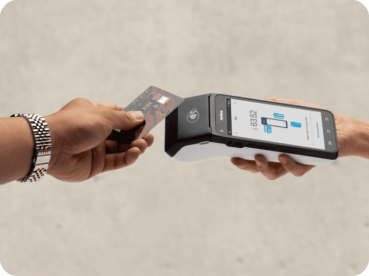 Hand tapping a credit card on a black mobile POS terminal