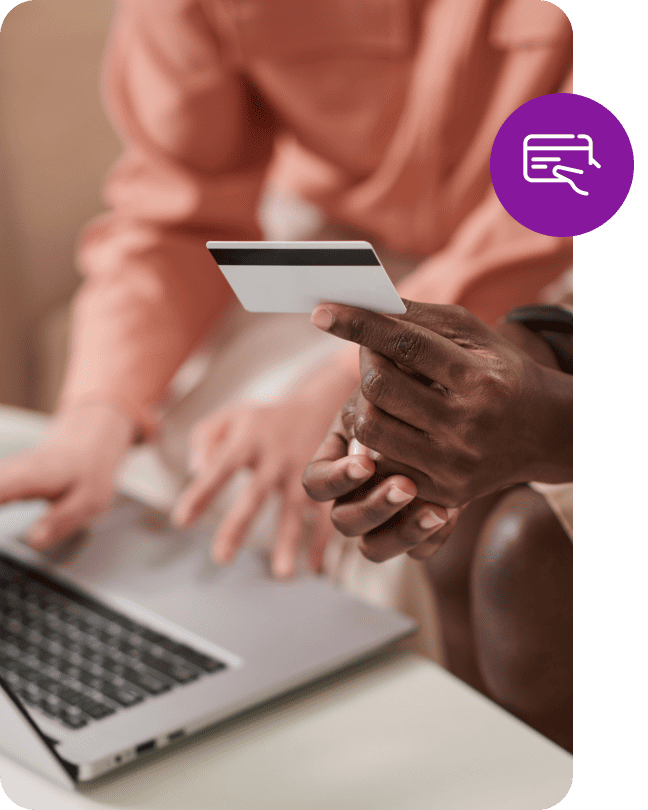 Person holding a credit card by a laptop with a purple payment icon overlay.