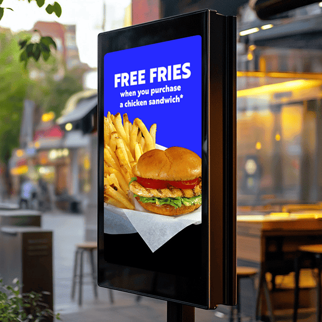 An image of an outdoor digital menu board displaying an offer for free fries.