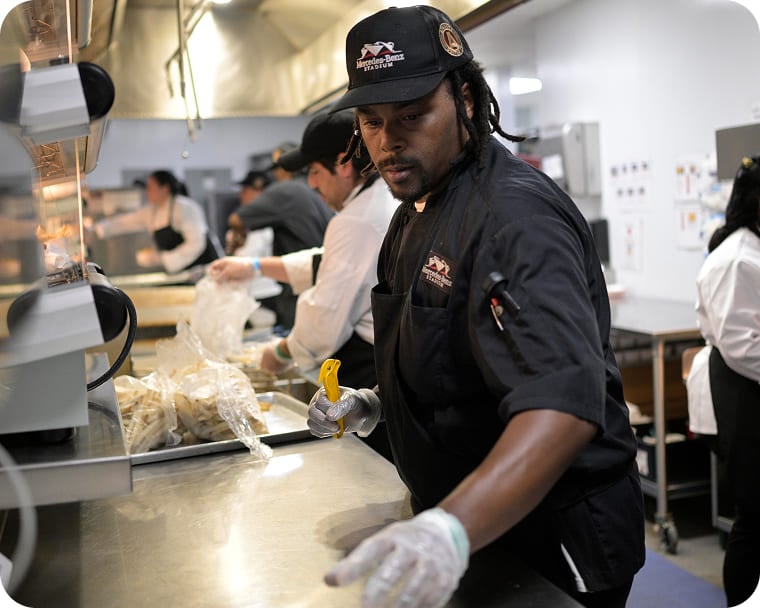 An image of a busy kitchen crew preparing orders.