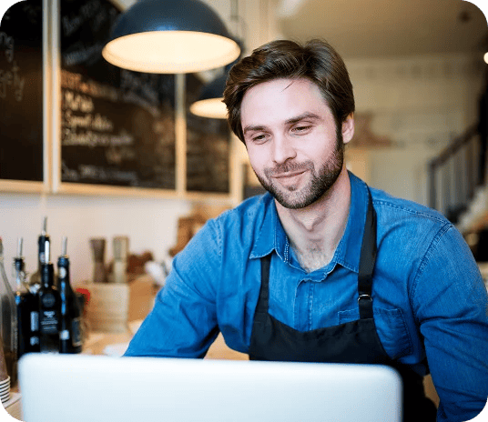 Restaurant owner using laptop