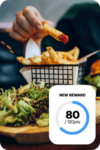 Customer enjoying fries while a rewards program card shows 80 of 120 points earned.
