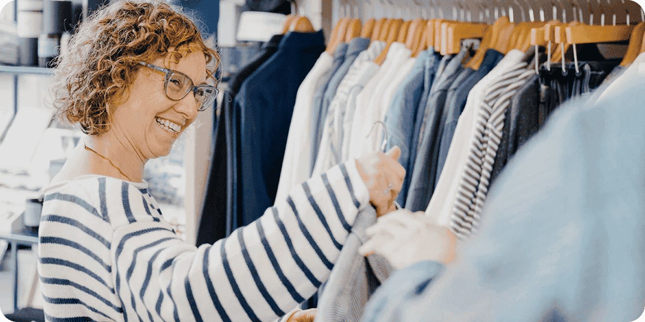 Woman shopping for clothes talks with an associate