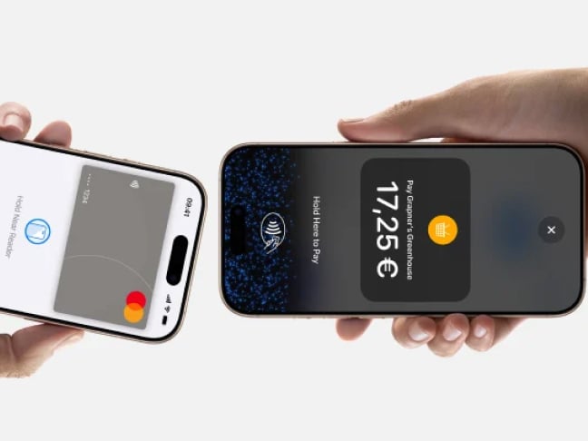Close up of two mobile phones making a contactless payment to one another